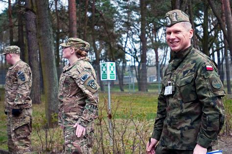 A Polish Army Officer Assists U S Army Military Police As Soldiers