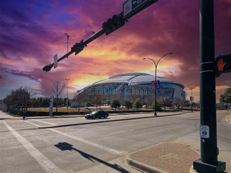 At And T Stadium Surrounded By Trees And Plants And Cars At Sunset In