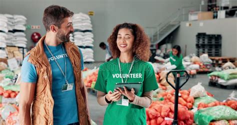 Tablet Talking And Volunteers At Food Drive Donation For Community Tablet Talking And Volunteers At Food Drive Donation For Community